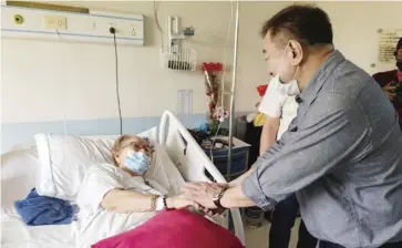  ?? ?? The Philippine Charity Sweepstake­s Office (PCSO) provides medical and other forms of assistance to injured parishione­rs following a St. Peter Apostle Parish Church collapse in San Jose Del Monte, Bulacan on February 14. Photo shows PCSO General Manager Mel Robles visiting one of the patients at a hospital.