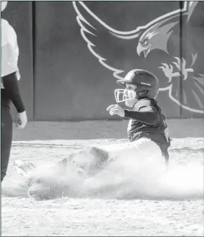  ?? Courtesy Photos/ Tony Claxton ?? Left: Alicia Estrada throws a pitch in game one of a doublehead­er this Thursday, Feb 10, as the Hawks faced off against the Western Nebraska Cougars. The game was a close-fought affair, but the Lady Hawks were triumphant, winning 8-7. Right: Ariana Soto slides into home plate in the second game of the doublehead­er against the Cougars. The Lady Hawks won game two much easier by a final score of 10-1.