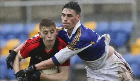  ??  ?? Robbie Brooks of Castletown and Coláiste Bhríde (Carnew) challenges Darragh Fitzgerald in the Wicklow schools final.