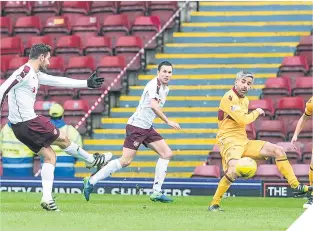  ??  ?? Hearts’ Alexandrio­s Tziolis scores from a deflection off Keith Lasley.