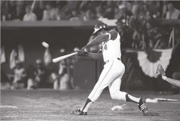  ?? JOE HOLLOWAY JR./ASSOCIATED PRESS ?? Hank Aaron hits his 715th career home run in Atlanta Stadium to break the all-time record set by Babe Ruth on Aug. 8, 1974. Aaron, who finished his illustriou­s career with 755 home runs, died peacefully in his sleep.