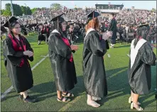  ?? SARAH GORDON/THE DAY ?? Graduates line up to receive their diplomas during commenceme­nt exercises for Montville High School on Monday.