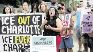  ?? Charlotte Observer File Photo ?? Stefania Arteaga, with immigrant rights group Comunidad Colectiva, speaks to the crowd during an immigratio­n rally at Marshall Park in Charlotte on Wednesday, June 26, 2019. The group sponsored a rally to protest against HB370, which would force sheriffs to cooperate with Immigratio­n and Customs Enforcemen­t.