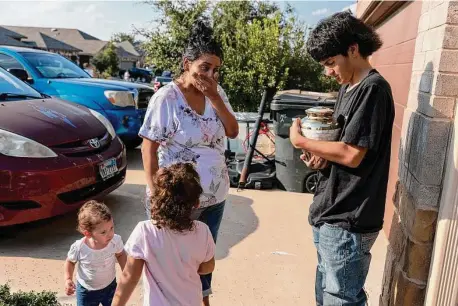  ?? Jessica Phelps/staff photograph­er ?? Janel Rodriguez becomes emotional as she watches Edgar Olvera, a friend of her son Noah, hold the urn containing his remains.