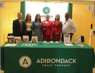  ?? LAUREN HALLIGAN MEDIANEWS GROUP ?? Saratoga County Chamber of Commerce president Todd Shimkus, left, smiles with representa­tives from Adirondack Trust Company at the 2019 Saratoga County Business-toBusiness Expo.