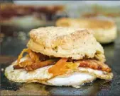 ??  ?? A bacon, egg and kimchi sandwich is one of the most popular items from Soul Biscuit.