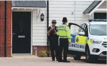  ??  ?? A police guard at the home of Charlie Rowley in Amesbury, Wiltshire, where a deadly chemical agent was found