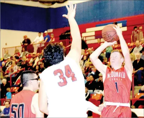  ?? RICK PECK/SPECIAL TO MCDONALD COUNTY PRESS ?? McDonald County’s Blake Gravette shoots over the outstretch­ed arms of Seneca’s Cameron Brattin during the Indians 61-55 overtime win on Jan. 12 at Seneca High School.