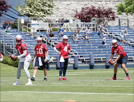  ?? Photo courtesy of the Patriots ?? Patriots quarterbac­ks Cam Newton (1), Mac Jones (50) and Jarrett Stidham (4) are at optional workouts this week in Foxboro to try and build synergy with a new group of wide receivers and tight ends.