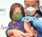  ?? MARY ALTAFFER/AP FILE ?? Maria Assisi holds her daughter Mia, 4, as the Moderna COVID-19 vaccine is administer­ed last month in New York.