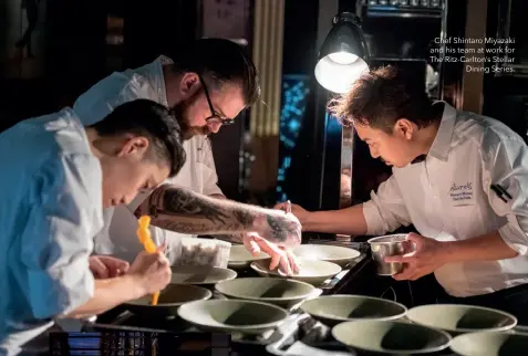  ??  ?? Chef Shintaro Miyazaki and his team at work for The Ritz-Carlton’s StellarDin­ing Series.