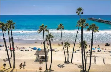  ?? Allen J. Schaben Los Angeles Times ?? BEACHGOERS hit the water Tuesday at the San Clemente Pier; sadly, the location is on Heal the Bay’s Beach Bummers list for poor water quality. In general, Southern California’s beach grades this year were high.