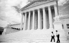 ?? ANDREW HARNIK/AP ?? Security officers walk in front of the Supreme Court on May 14 in Washington.