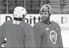  ?? ROSS D. FRANKLIN/AP PHOTO ?? Capitals goaltender Braden Holtby, right, talks with right wing T.J. Oshie during practice on Tuesday at Las Vegas.