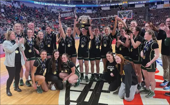  ?? ANDREW ROBINSON — FOR MEDIANEWS GROUP ?? The Archbishop Wood girls basketball team takes a photo with the PIAA championsh­ip trophy and a giant bar of chocolate after its 37-27win over Cathedral Prep in the Class 5A final on Saturday, March 23, 2024 at Giant Center in Hershey.
