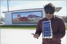  ?? JULIO MORALES PHOTO ?? Imperial Avenue Holbrook High School junior Richie Rosas holds a solar-powered model car that he and a classmate intend to enter into an upcoming local MESA competitio­n Wednesday.