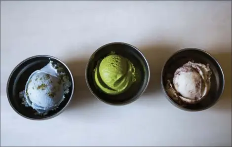  ?? MICHAEL NOBLE JR. — THE ASSOCIATED PRESS ?? Three flavors of vegan ice cream — from left, Planet Earth, Matcha Green Tea, and Toasted Coconut Brownie Sundae — are on display at a Van Leeuwen shop in the Brooklyn borough of New York. Van Leeuwen serves both dairy and non-dairy artisan ice cream...