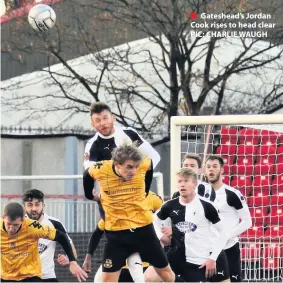  ??  ?? ■ Gateshead’s Jordan Cook rises to head clear PIC: CHARLIE WAUGH