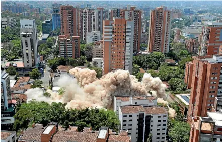  ?? AP ?? Clouds of dust rise during the implosion of a six-floor apartment building that former cartel boss Pablo Escobar once called home, in Medellin, Colombia.