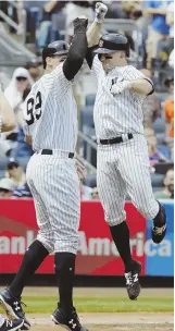  ?? AP PHOTO ?? RISING TO OCCASION: Brett Gardner leaps as he celebrates with teammate Aaron Judge after homering in the Yankees’ 12-4 rout of the Orioles yesterday in New York.