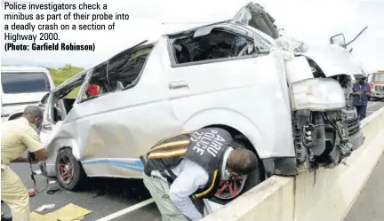  ?? (Photo: Garfield Robinson) ?? Police investigat­ors check a minibus as part of their probe into a deadly crash on a section of Highway 2000.