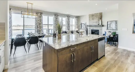  ?? PHOTOS: TRICO HOMES ?? The grand central kitchen in the 2,303-square-foot Fairmont by Trico Homes has a considerab­le amount of space around the central island.