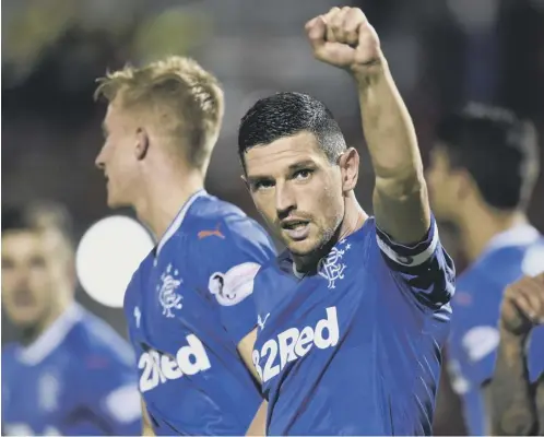  ??  ?? Graham Dorrans, who captained Rangers against Hamilton last night, acknowledg­es the fans after his penalty made the score 4-1.