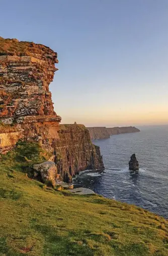  ?? Photo: iStock ?? RUGGED BEAUTY: The cliffs of Moher in County Clare form an epic backdrop to some of the Wild Atlantic Way’s popular surf beaches.