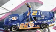  ?? ?? Joey Logano stands on his car after winning the NASCAR Cup Series race at Atlanta Motor Speedway on Sunday. Hakim Wright Sr. / Associated press