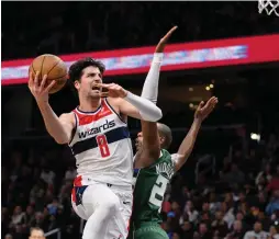  ?? ?? WASHINGTON WIZARDS Israeli forward Deni Avdija drives to the basket against Milwaukee Bucks defender Khris Middleton for two of his 23 points in the Wizards’ 117-113 home victory over the Bucks.