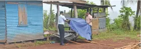  ??  ?? Police covering the body of a man found near the farm house in Vunikawaka­wa in Labasa on July 28, 2019.