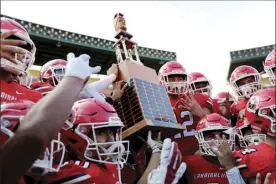  ?? ANDREW LEE photo ?? Members of the Lahainalun­a football team celebrate with the championsh­ip trophy after winning their fourth consecutiv­e D-II state title on Nov. 29 at Aloha Stadium.