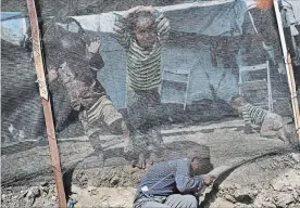  ??  ?? Syrian children play outside their family tent at a makeshift camp outside Moria. Doctors at a health clinic at the site say they have to turn sick children away every day.