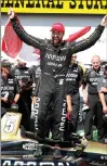  ?? Associated Press photo ?? James Hinchcliff­e celebrates after winning an IndyCar Series auto race Sunday at Iowa Speedway in Newton, Iowa.