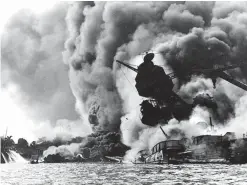  ??  ?? PEARL HARBOR, Hawaii: This December, 1941 file photo shows the USS Arizona, sunk and burning furiously. Her forward magazines had exploded when she was hit by a Japanese bomb. — AFP