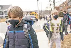  ?? ?? Battling ‘educationa­l inequities’?: Kids in masks outside a school in Feb.