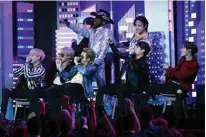  ??  ?? US rapper Lil Nas X (center) and South Korean boy band BTS perform
onstage.