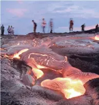  ?? USA TODAY FILE ?? Visitors to Hawaii Volcanoes National Park view a surface flow of lava from the Pu'u O'o vent on the slope of the Kilauea caldera, which began erupting in 1983. It is a three-mile round trip hike over fresh lava fields (no paved trail) to get to this flow at the end of Chain of Craters Road.