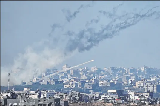  ?? Ariel Schalit The Associated Press ?? Rockets are fired toward Israel from the Gaza Strip, as seen Friday from southern Israel.