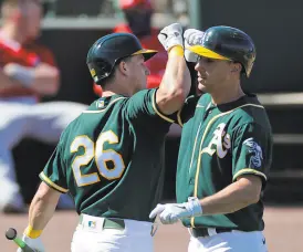  ?? Carlos Avila Gonzalez / The Chronicle ?? The A’s cornerston­e infielders, Matt Olson (left) at third base and Matt Chapman at first, hope to put 2020 behind them.