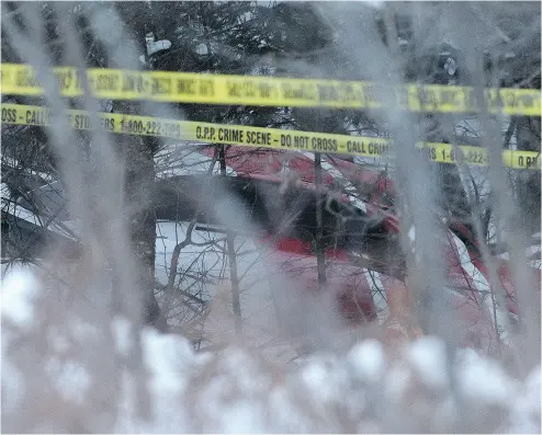  ?? LARS HAGBERG / THE CANADIAN PRESS ?? An Ontario Hydro One helicopter can be seen at the crash site near Tweed, Ont., west of Kingston, on Thursday.