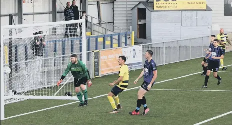  ??  ?? ACUTE ANGLE Paulsgrove’s Aaron Fennemore, far right, scores from virtually on the touchline at Westleigh Park