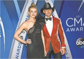  ?? EVAN AGOSTINI/ INVISION/ AP ?? Faith Hill and Tim McGraw made sure to hit the red carpet before the 51st annual CMA Awards in Nashville.