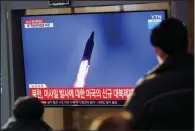  ?? (AP/Lee Jin-man) ?? People at a train station in Seoul, South Korea, watch a TV screen showing a news program reporting about North Korea’s missile launch Friday.