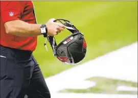  ?? Tyler Kaufman Associated Press ?? A STAFF MEMBER is shown wearing a Kinexon SafeTag on his wrist before a game in September. The NFL finished its season without canceling a game.