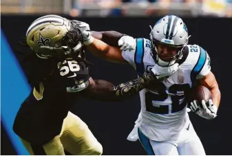  ?? Jacob Kupferman / Associated Press ?? The Panthers’ Christian McCaffrey pushes away from Saints linebacker Demario Davis in the second half. McCaffrey, a Stanford standout, had 137 yards from scrimmage and a touchdown.