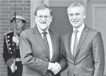  ??  ?? Spanish Prime Minister Mariano Rajoy (L) shakes hands with NATO Secretary General Jens Stoltenber­g prior to holding a meeting at ‘La Moncloa’ palace in Madrid. - AFP photo