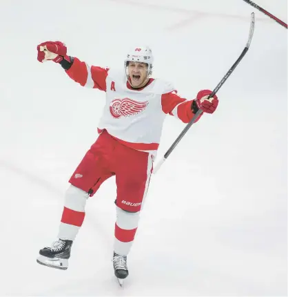  ?? ARMANDO L. SANCHEZ/CHICAGO TRIBUNE ?? Red Wings right wing Patrick Kane celebrates after scoring the game-winning goal against the Blackhawks in overtime Sunday at the United Center.