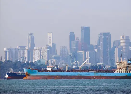  ??  ?? Oil tankers pass the skyline of Singapore in this June 8, 2016, file photo. (Reuters)