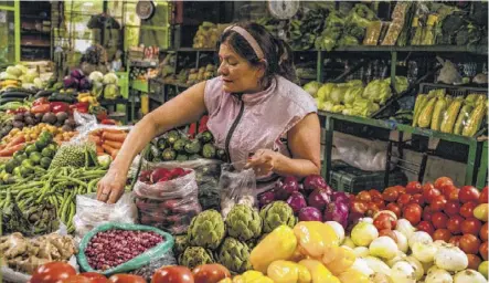  ??  ?? At the Paloquemao market, you can find everything from local produce and fresh juices to bird cages and magical potions.